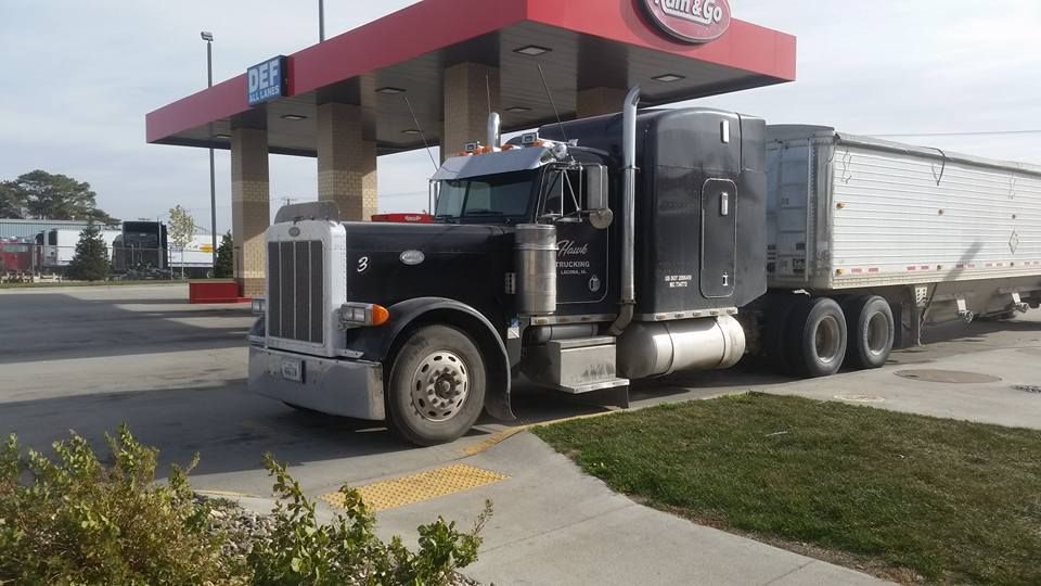 black Peterbilt 379 fueling up at fuel island black Peterbilt 379 fueling up at fuel island